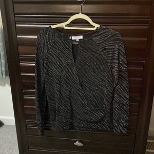 Black top with shiny silver accents with keyhole tops and wrap accent at waist